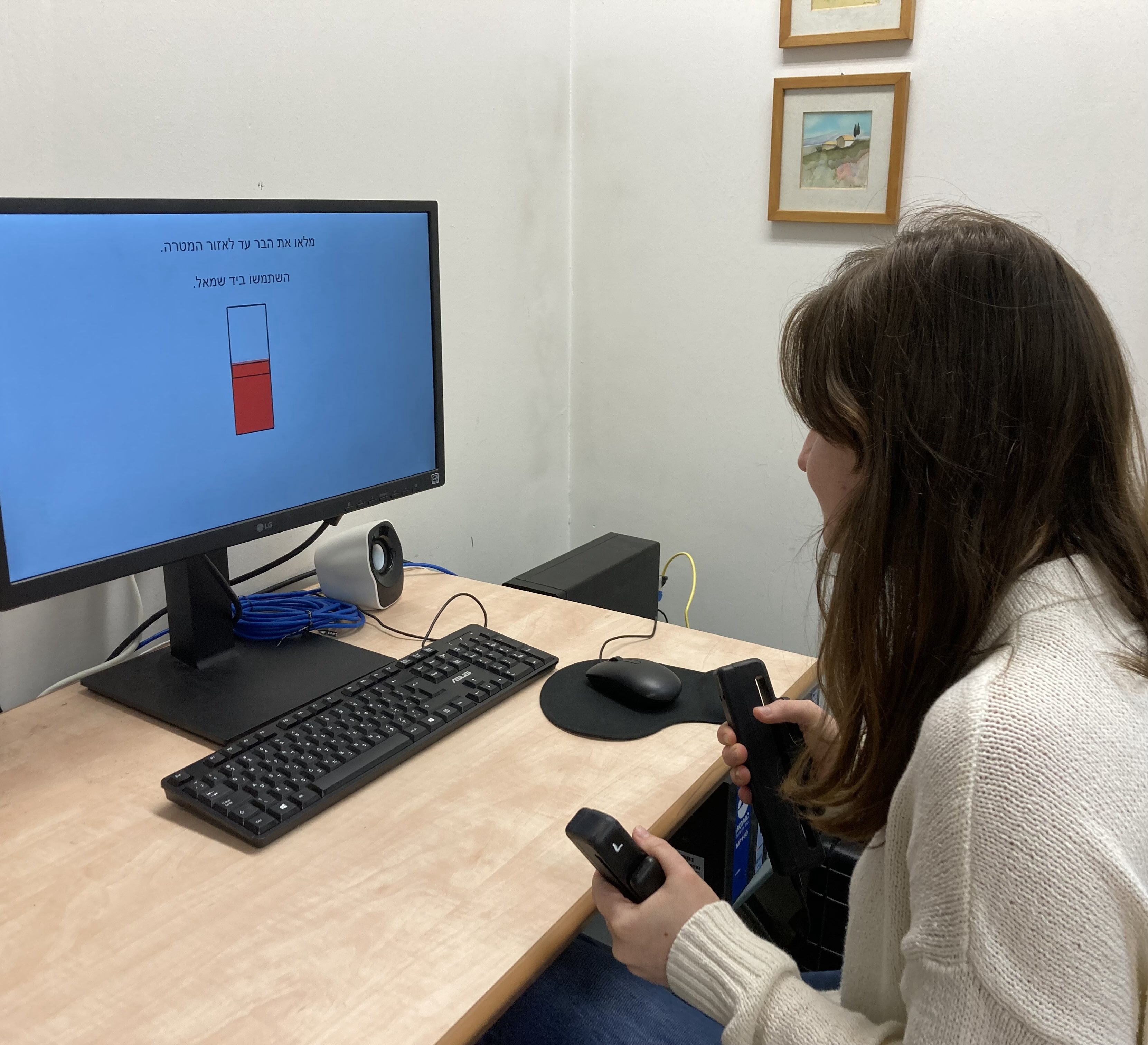A participant using a handgrip device during a lab effort task